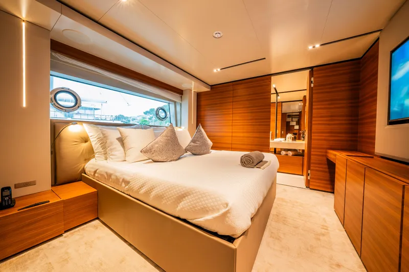 Sk Yacht Photos Pics Luxurious bedroom interior on 2019 Custom Line Navetta 33 yacht, featuring elegant wood finishes.