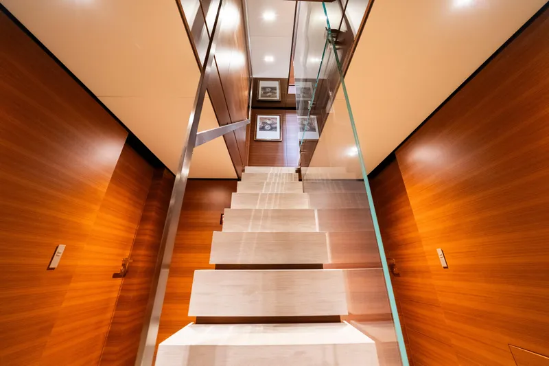Sk Yacht Photos Pics Luxurious wooden staircase inside 2019 Custom Line Navetta 33 yacht, featuring modern design elements.