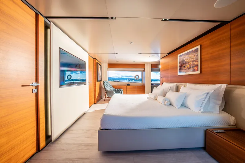Sk Yacht Photos Pics Luxurious 2019 Custom Line Navetta 33 yacht bedroom with modern wood paneling and scenic window view.