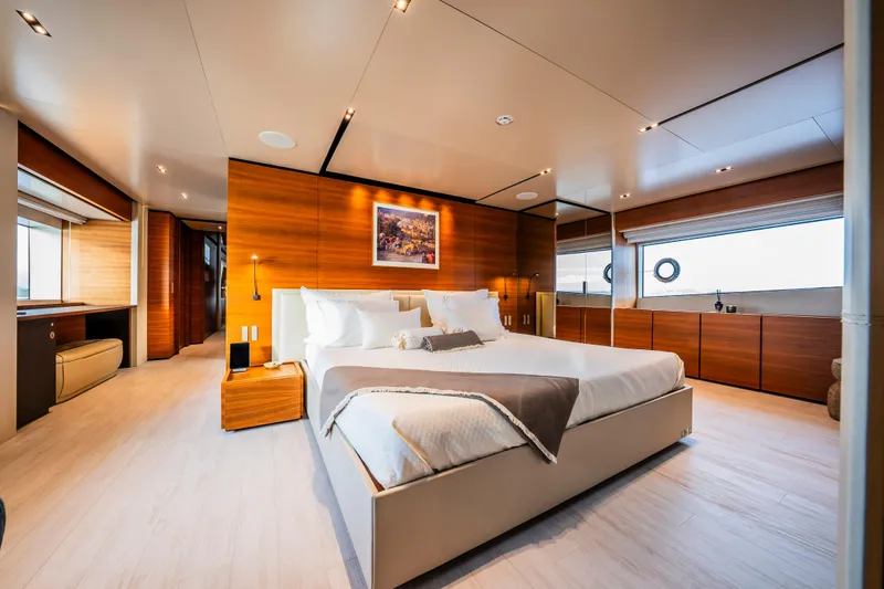 Sk Yacht Photos Pics Luxurious bedroom interior on 2019 Custom Line Navetta 33 yacht, featuring elegant wood paneling.
