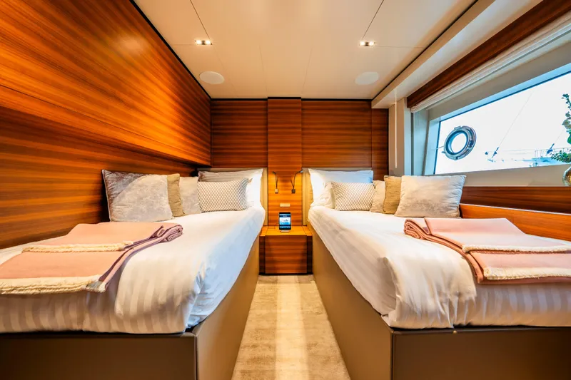Sk Yacht Photos Pics Luxurious twin cabin on 2019 Custom Line Navetta 33 yacht, featuring elegant wood paneling.