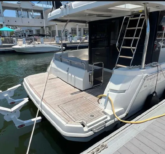  Yacht Photos Pics 2021 Beneteau Swift Trawler 41 Fly at marina, rear view with swim platform.