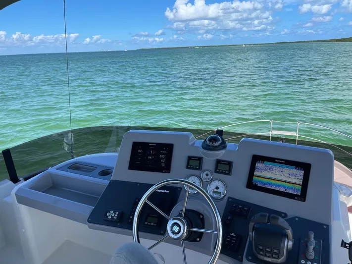  Yacht Photos Pics Beneteau Swift Trawler 41 Fly 2021 helm with ocean view and navigation equipment.