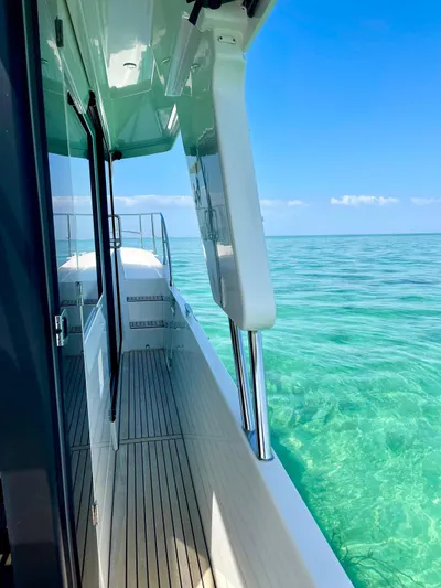  Yacht Photos Pics 2021 Beneteau Swift Trawler 41 Fly on clear turquoise water, side deck view.