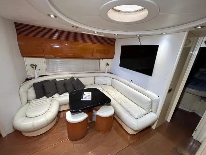 54' Pershing Express Yacht Photos Pics Luxurious interior of a 1999 Pershing 54 yacht with white leather seating and a flat-screen TV.