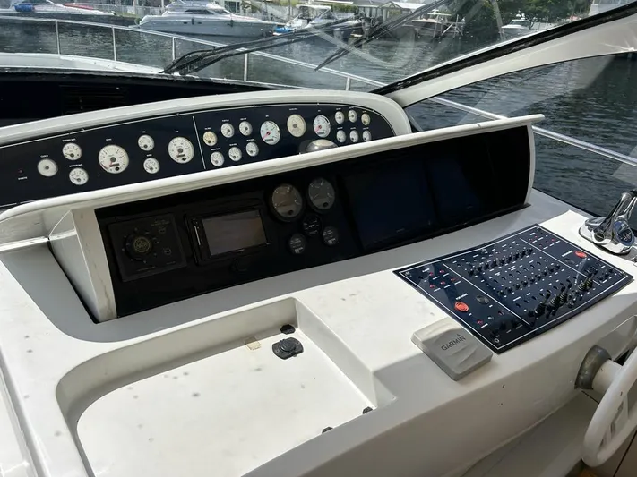 54' Pershing Express Yacht Photos Pics Control panel of a 1999 Pershing 54 yacht with various gauges and navigation equipment.