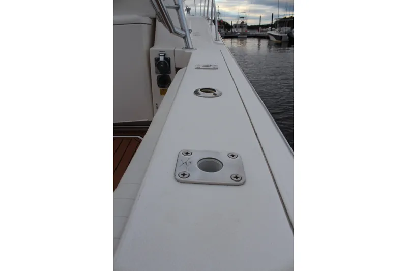 Holly Ann Yacht Photos Pics 2005 Rampage 38 Express boat deck with rod holders, docked at marina.