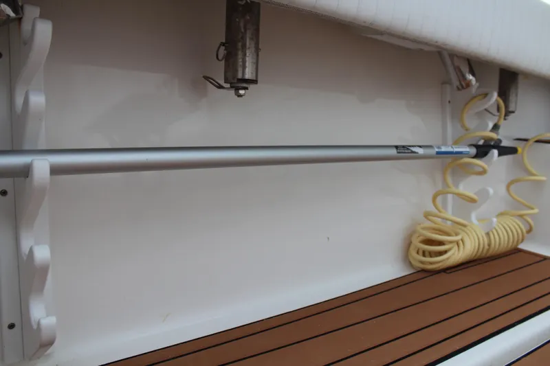 Holly Ann Yacht Photos Pics 2005 Rampage 38 Express boat interior with mounted rod and coiled hose.