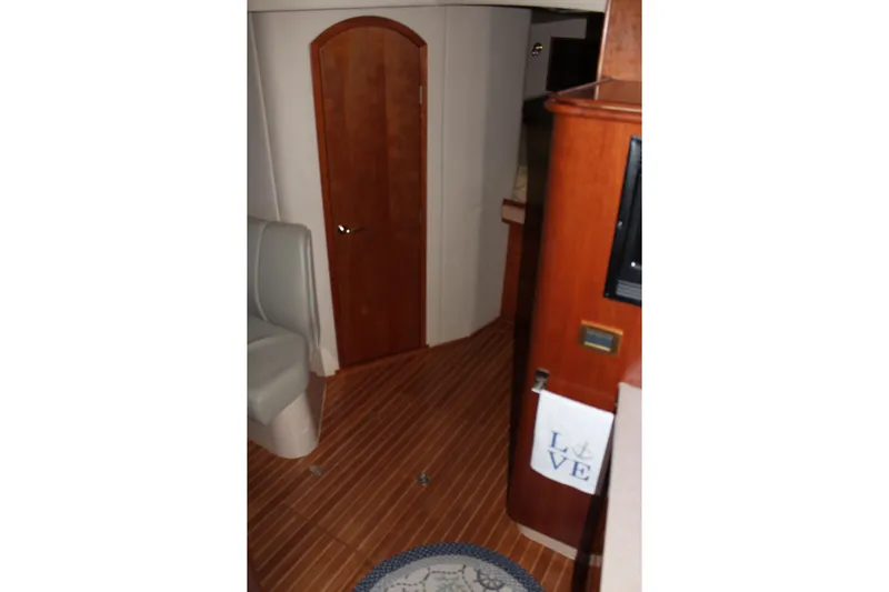 Holly Ann Yacht Photos Pics Interior of 2005 Rampage 38 Express yacht with wooden flooring and cozy seating.