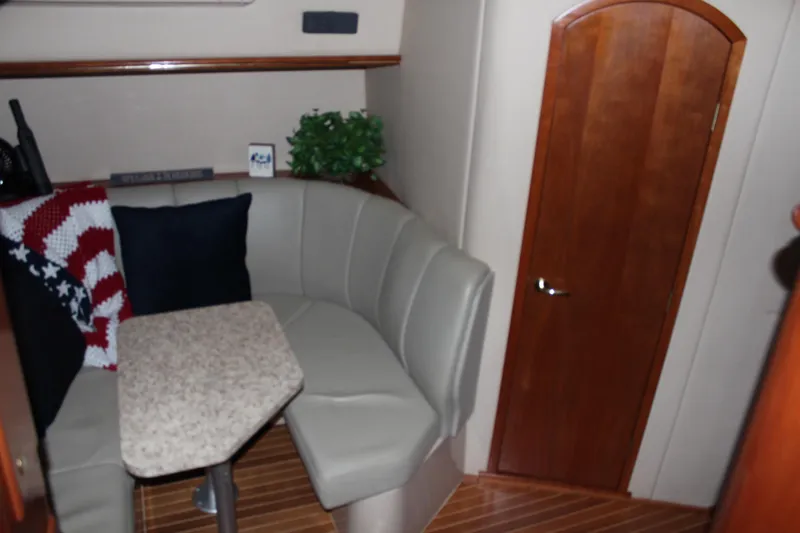 Holly Ann Yacht Photos Pics 2005 Rampage 38 Express cabin with cozy seating and wooden door.