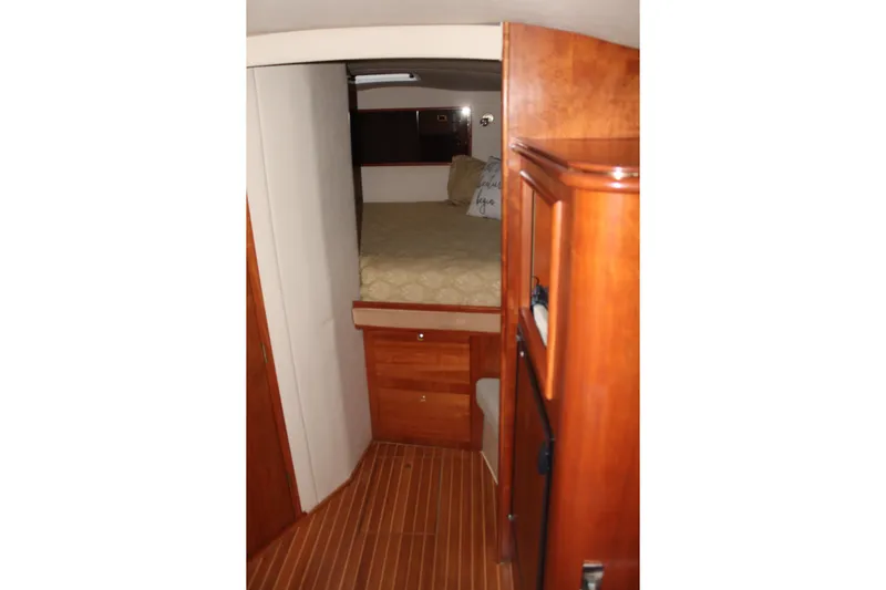 Holly Ann Yacht Photos Pics 2005 Rampage 38 Express cabin interior with wooden finish and cozy bed.