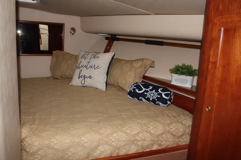 Holly Ann Yacht Photos Pics Cozy cabin interior of 2005 Rampage 38 Express with decorative pillows and bedding.