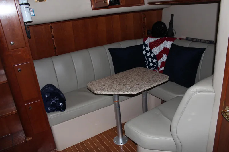 Holly Ann Yacht Photos Pics 2005 Rampage 38 Express cabin with cozy seating and a small table.