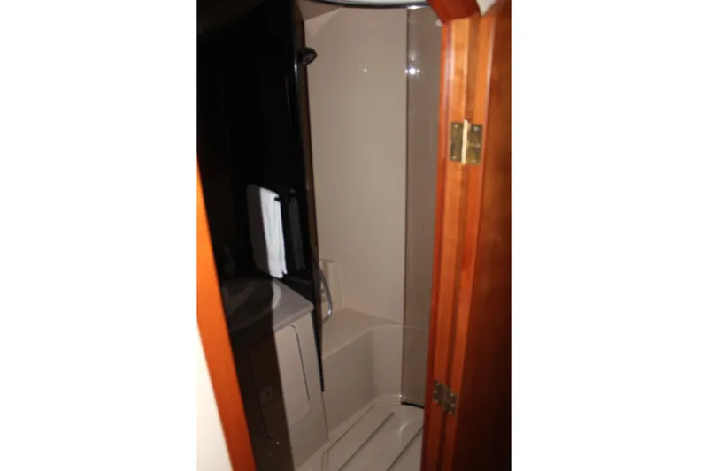 Holly Ann Yacht Photos Pics 2005 Rampage 38 Express boat bathroom with shower and wooden door.