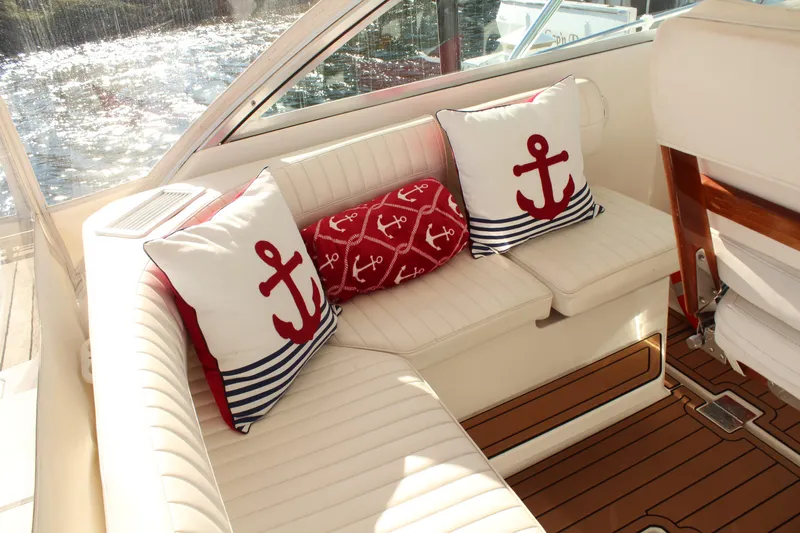 Holly Ann Yacht Photos Pics Luxurious 2005 Rampage 38 Express boat interior with nautical-themed cushions and elegant seating.