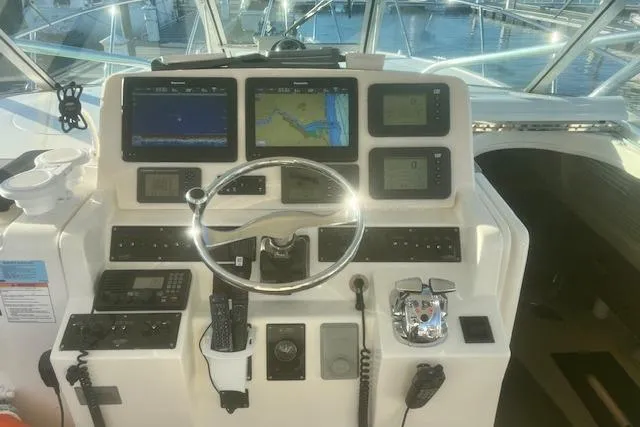 Holly Ann Yacht Photos Pics Control panel of a 2005 Rampage 38 Express boat with navigation screens and instruments.