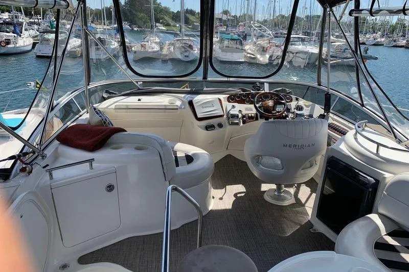  Yacht Photos Pics 2007 Meridian 341 Sedan yacht interior with helm, marina view, and luxurious seating.