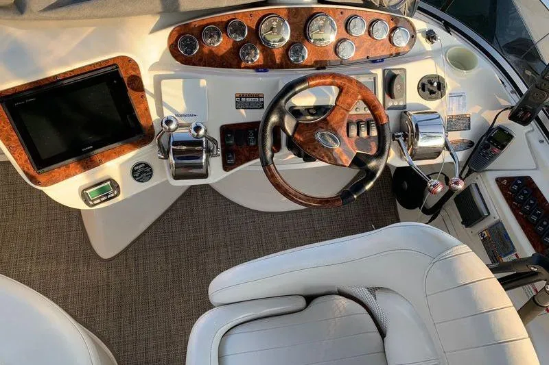  Yacht Photos Pics 2007 Meridian 341 Sedan helm with wood accents, gauges, and steering wheel.