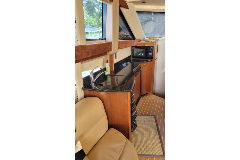  Yacht Photos Pics Interior of 2007 Meridian 341 Sedan yacht with kitchenette and seating area.