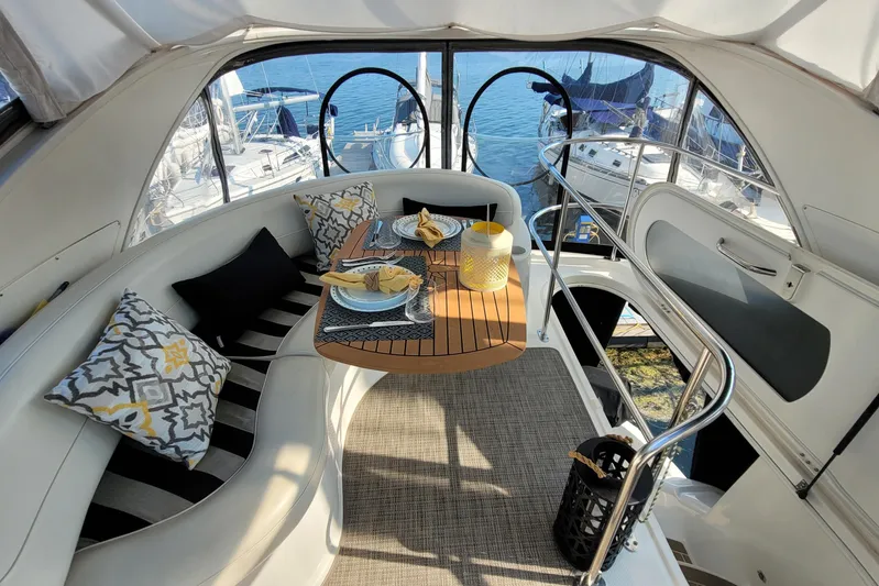  Yacht Photos Pics Luxurious 2007 Meridian 341 Sedan yacht interior with elegant dining setup and scenic marina view.