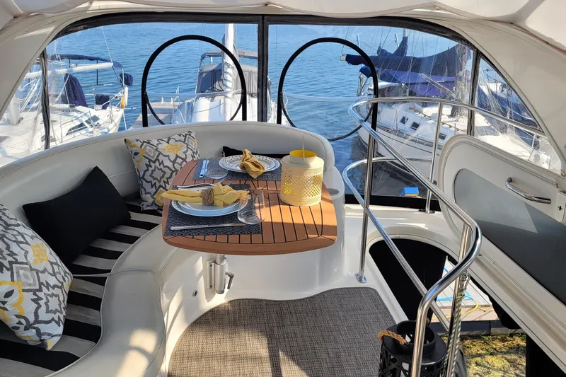  Yacht Photos Pics Luxurious 2007 Meridian 341 Sedan yacht interior with elegant dining setup and scenic marina view.