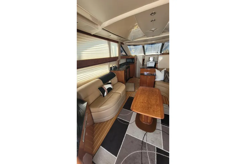  Yacht Photos Pics Luxurious interior of 2007 Meridian 341 Sedan yacht with elegant seating and wooden table.