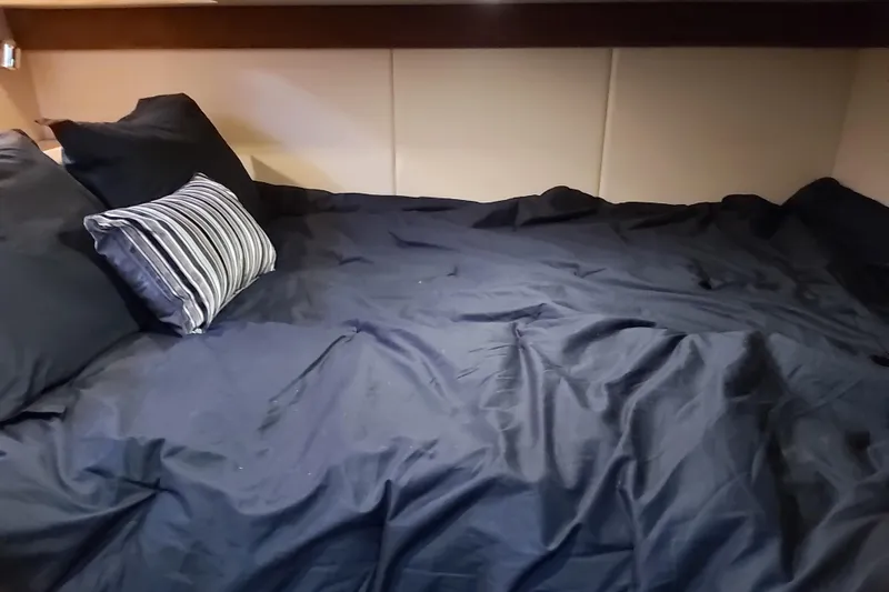 Yacht Photos Pics Cozy bed with dark bedding in 2007 Meridian 341 Sedan cabin.
