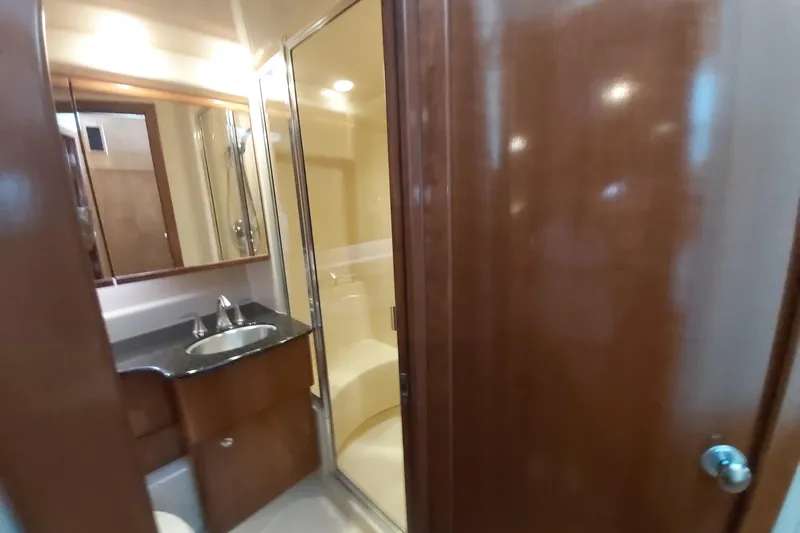  Yacht Photos Pics Luxurious bathroom in 2007 Meridian 341 Sedan yacht with wood accents and modern fixtures.