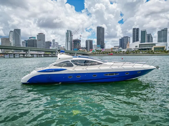  Yacht Photos Pics Azimut Atlantis 55 yacht from 2005 on water with city skyline background.