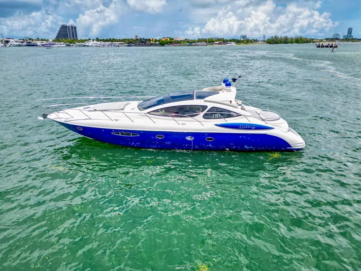  Yacht Photos Pics 2005 Azimut Atlantis 55 yacht cruising on a sunny day in clear waters.