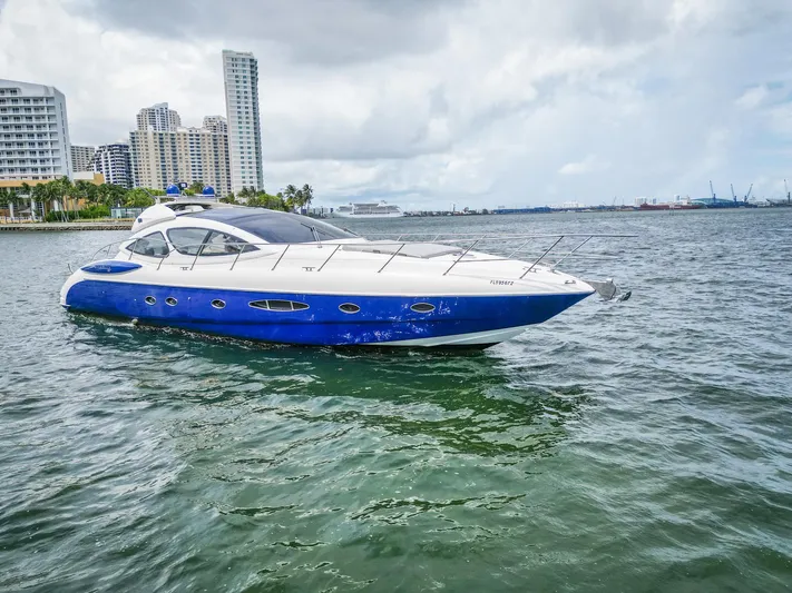  Yacht Photos Pics 2005 Azimut Atlantis 55 yacht cruising near city skyline on a cloudy day.