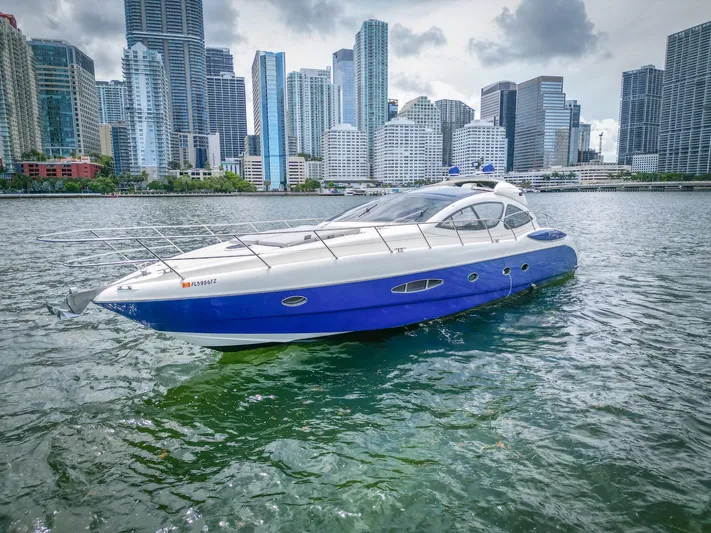 Yacht Photos Pics 2005 Azimut Atlantis 55 yacht on water with city skyline background.