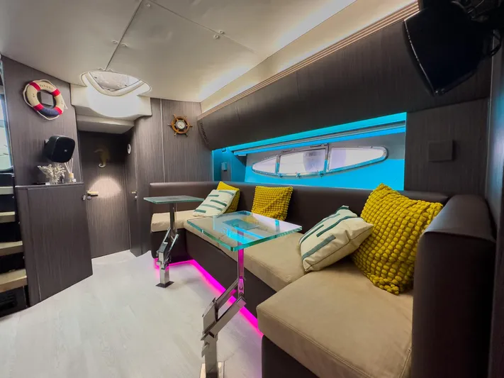  Yacht Photos Pics Luxurious interior of 2005 Azimut Atlantis 55 yacht with modern seating and vibrant lighting.