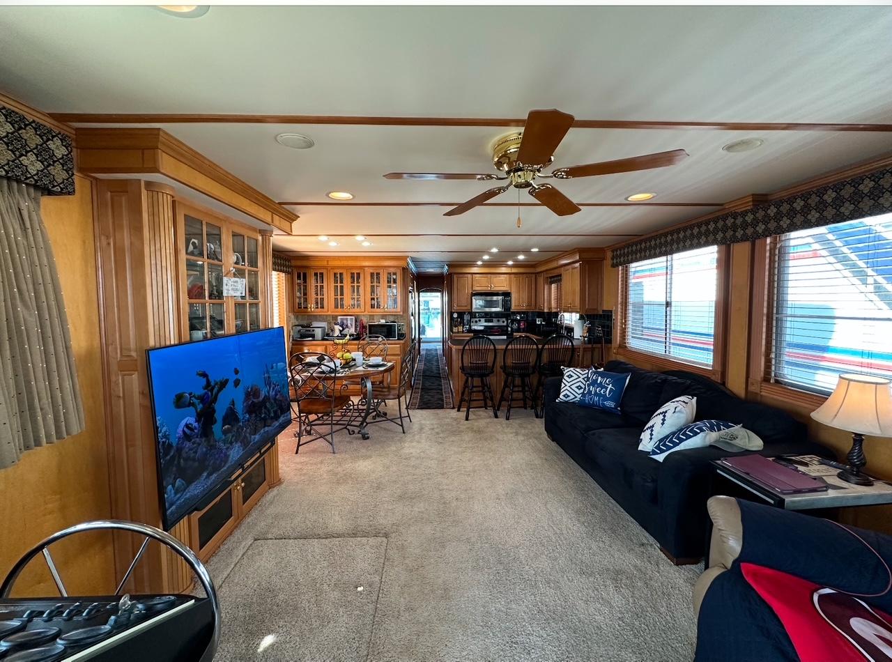 Spacious 2006 Lakeview 16x68 houseboat interior with modern kitchen, cozy living area, and large windows.