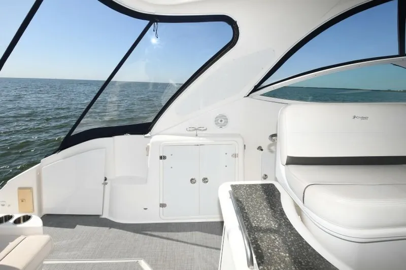 Time 'n Material Yacht Photos Pics 2007 Cruisers Yachts 420 Express interior with ocean view, featuring sleek white seating and cabinetry.