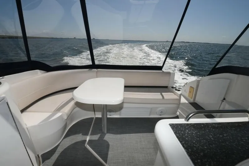 Time 'n Material Yacht Photos Pics 2007 Cruisers Yachts 420 Express interior with ocean view, featuring seating and table.