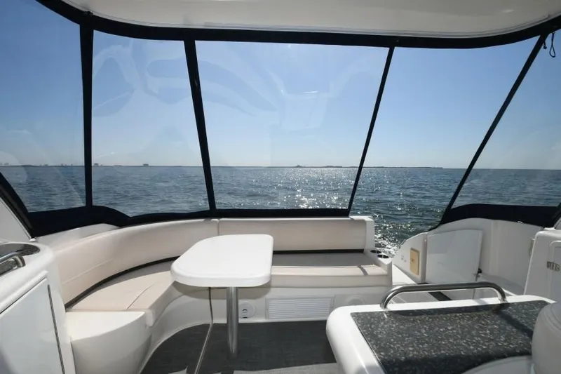 Time 'n Material Yacht Photos Pics 2007 Cruisers Yachts 420 Express interior with ocean view, featuring seating and table.