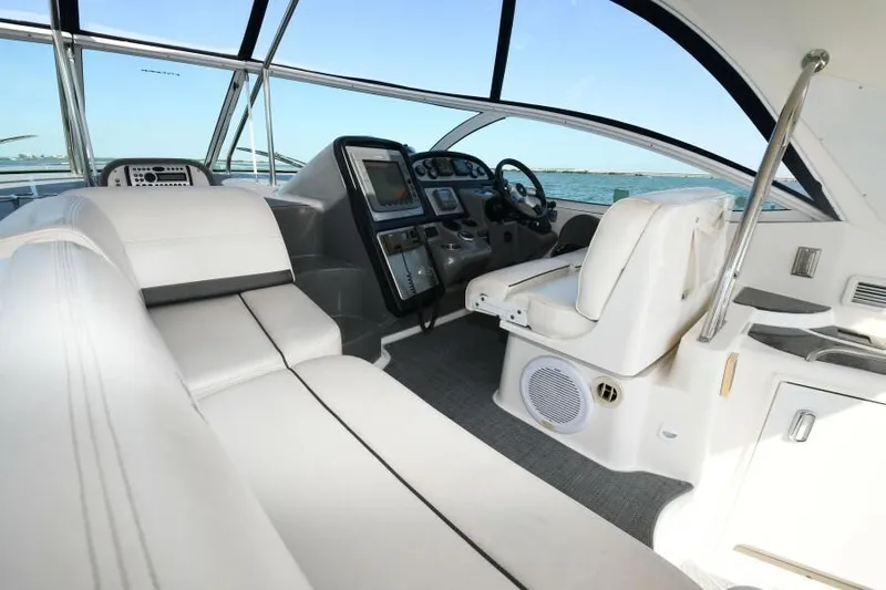 Time 'n Material Yacht Photos Pics 2007 Cruisers Yachts 420 Express cockpit with white seating and modern controls.