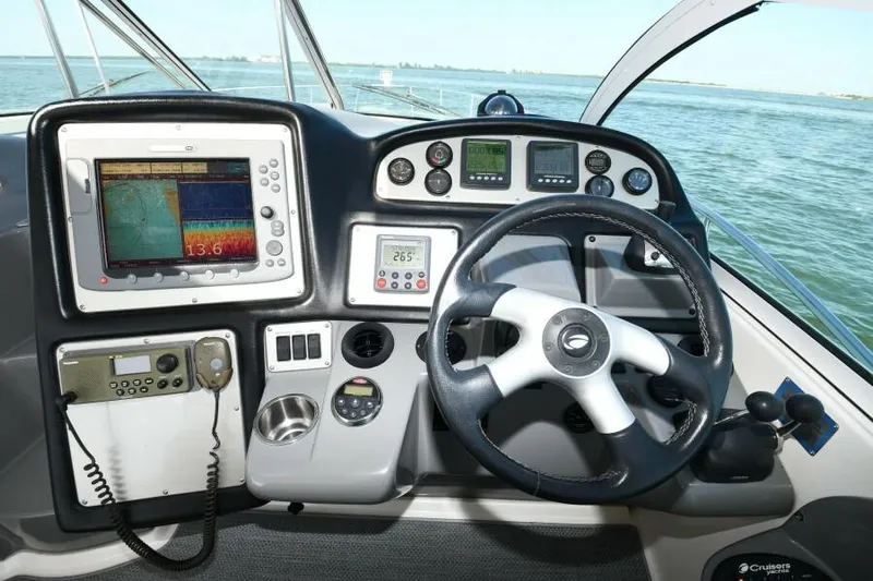 Time 'n Material Yacht Photos Pics Helm of 2007 Cruisers Yachts 420 Express with navigation equipment and steering wheel.