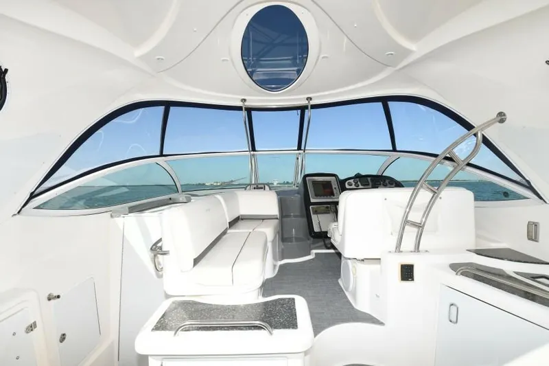 Time 'n Material Yacht Photos Pics 2007 Cruisers Yachts 420 Express interior with sleek white seating and panoramic windows.