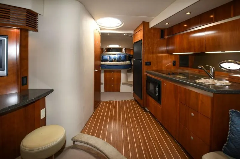 Time 'n Material Yacht Photos Pics Interior of 2007 Cruisers Yachts 420 Express, featuring wood cabinetry and modern amenities.