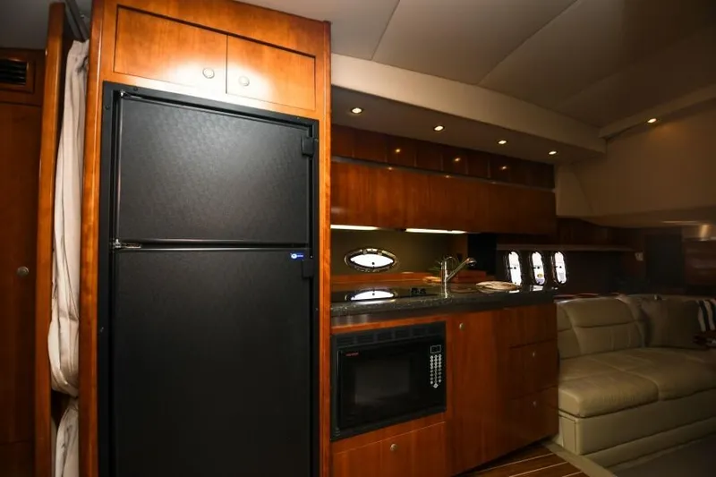 Time 'n Material Yacht Photos Pics Luxurious 2007 Cruisers Yachts 420 Express interior with kitchen and seating area.