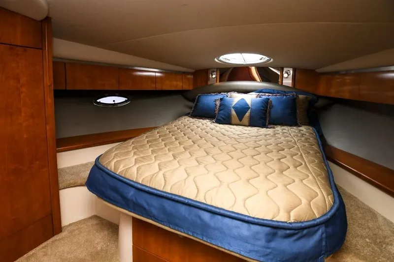 Time 'n Material Yacht Photos Pics Luxurious cabin interior of 2007 Cruisers Yachts 420 Express with cozy bed and elegant wood finish.