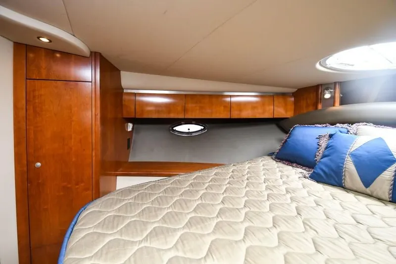 Time 'n Material Yacht Photos Pics Luxurious cabin interior of 2007 Cruisers Yachts 420 Express with wood finish and bedding.