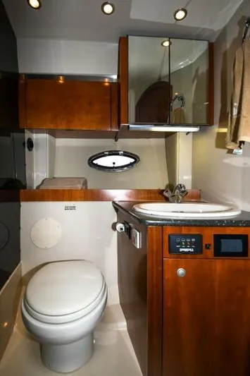 Time 'n Material Yacht Photos Pics 2007 Cruisers Yachts 420 Express bathroom with wood cabinetry and modern fixtures.