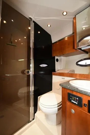 Time 'n Material Yacht Photos Pics Luxurious bathroom in 2007 Cruisers Yachts 420 Express with modern fixtures and wood accents.