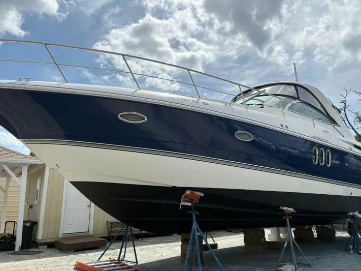 Time 'n Material Yacht Photos Pics 2007 Cruisers Yachts 420 Express on stands, under a cloudy sky.