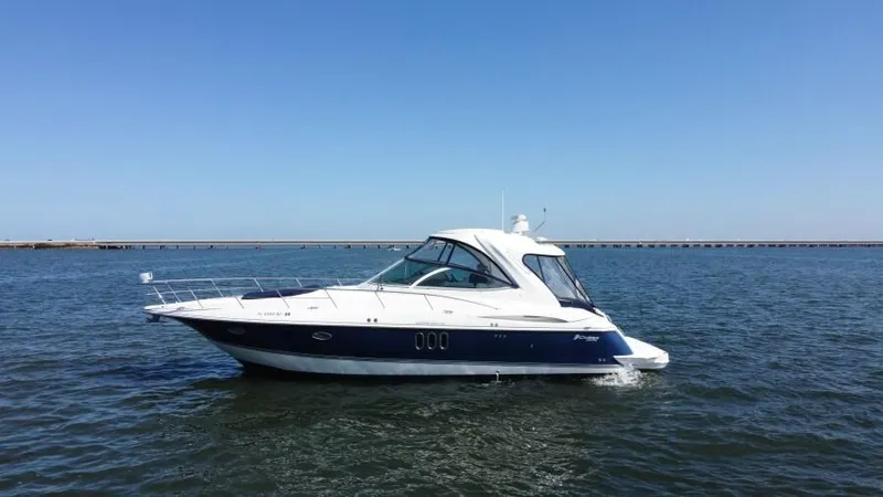 Time 'n Material Yacht Photos Pics 2007 Cruisers Yachts 420 Express on open water under clear blue sky.