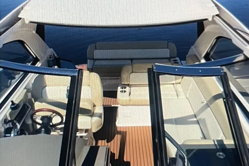 River Time Yacht Photos Pics 2012 Regal 35 Sport Coupe interior with beige seating and wooden flooring.