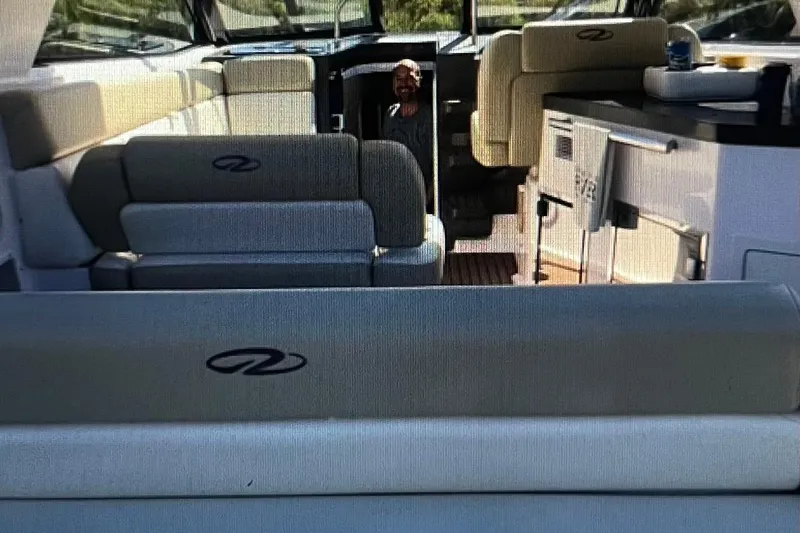 River Time Yacht Photos Pics Interior of a 2012 Regal 35 Sport Coupe boat with seating and kitchenette.